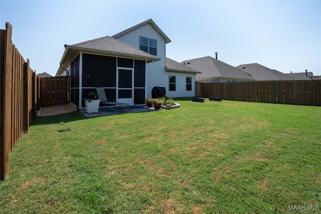 back of house featuring a sunroom and a yard