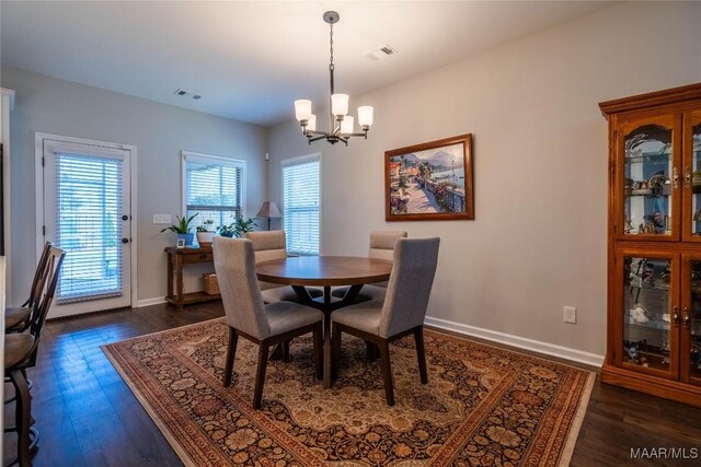 dining room featuring a notable chandelier and dark hardwood / wood-style flooring