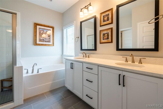 bathroom featuring tile patterned flooring, vanity, and plus walk in shower