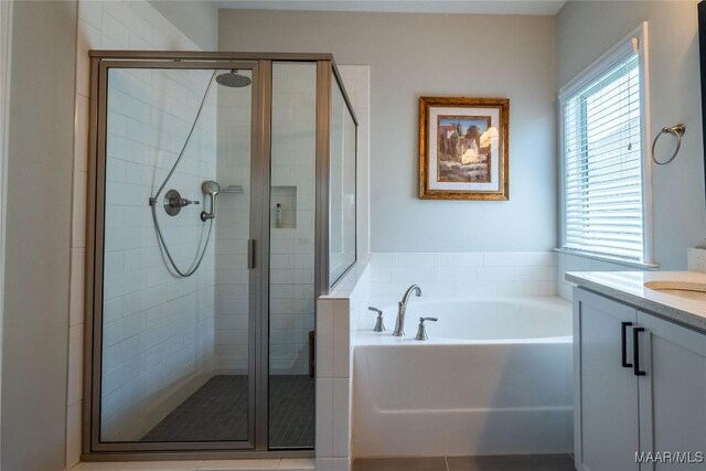 bathroom featuring vanity and shower with separate bathtub