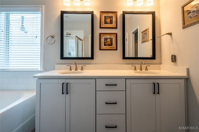 bathroom with vanity and shower with separate bathtub