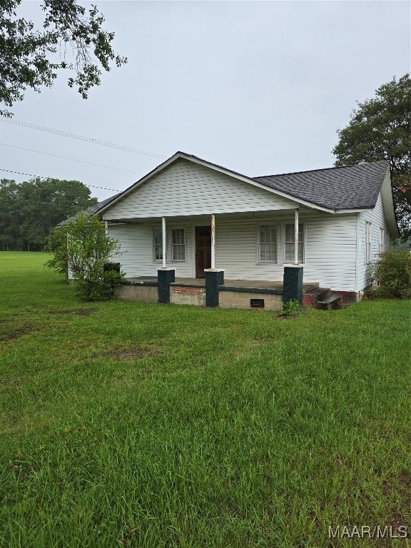 view of front of home with a porch and a front yard