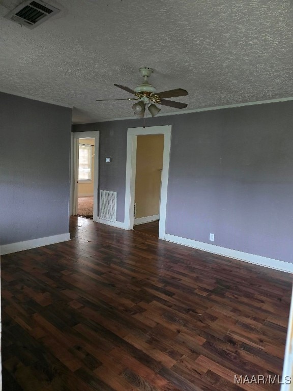 spare room featuring ceiling fan, hardwood / wood-style flooring, and a textured ceiling