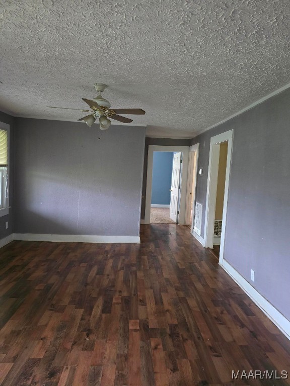 spare room featuring ceiling fan, hardwood / wood-style floors, and a textured ceiling