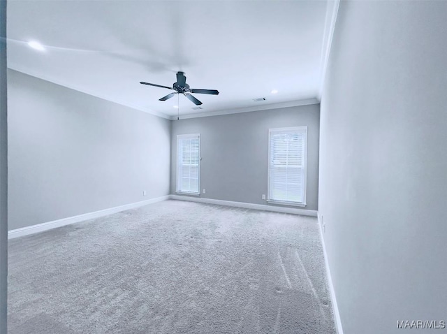 empty room with ornamental molding, carpet flooring, and ceiling fan