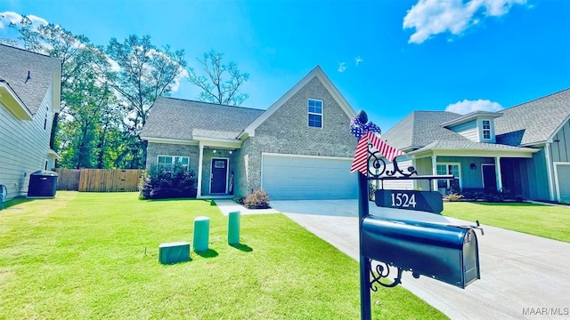 view of front of house with a garage, central AC, and a front yard