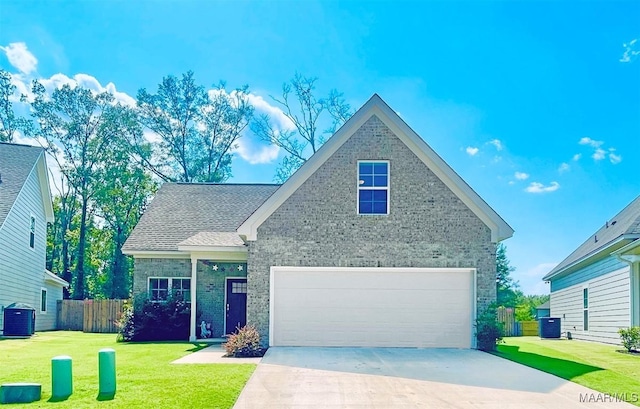 view of front facade with a garage, central air condition unit, and a front lawn