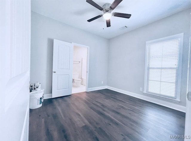 unfurnished bedroom with ceiling fan, connected bathroom, and dark hardwood / wood-style flooring