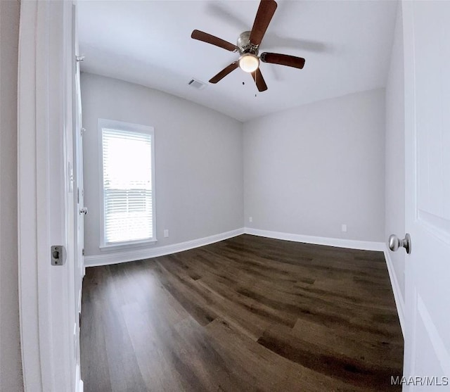 unfurnished room featuring dark hardwood / wood-style floors and ceiling fan