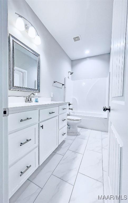 full bathroom with vanity, washtub / shower combination, and toilet