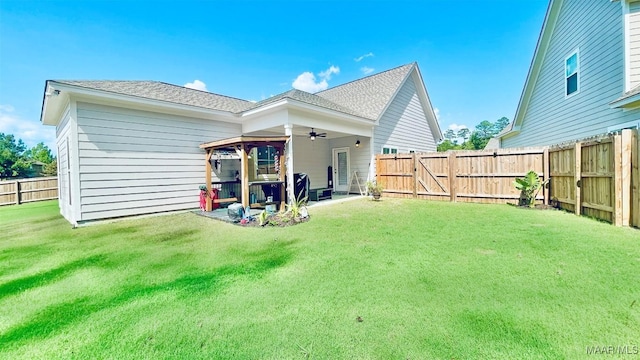 back of house with a gazebo, a yard, and ceiling fan