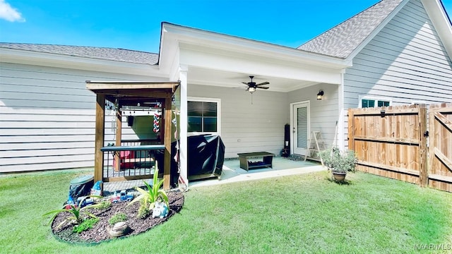 back of house featuring a patio, a yard, and ceiling fan