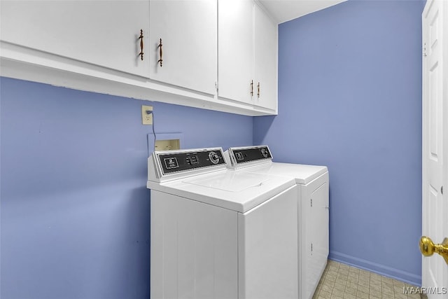 washroom with cabinets and washer and clothes dryer