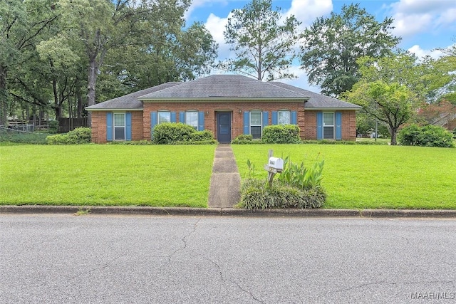 ranch-style home featuring a front yard