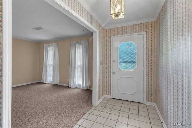 entrance foyer with light colored carpet and ornamental molding