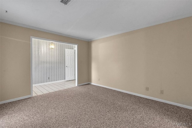 spare room featuring ornamental molding and light colored carpet