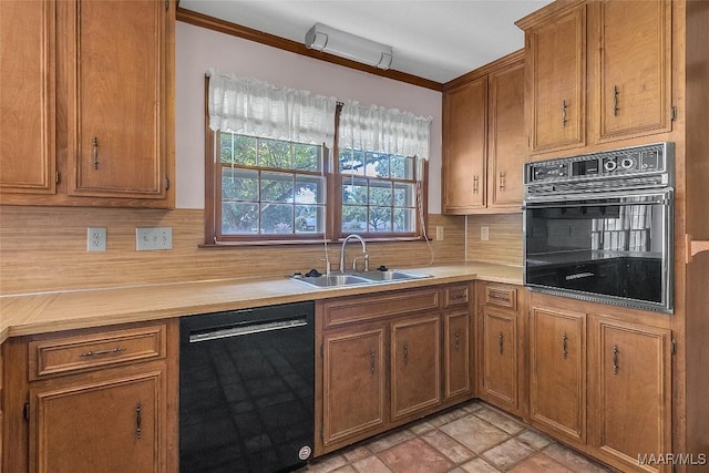 kitchen with tasteful backsplash, ornamental molding, sink, and black appliances