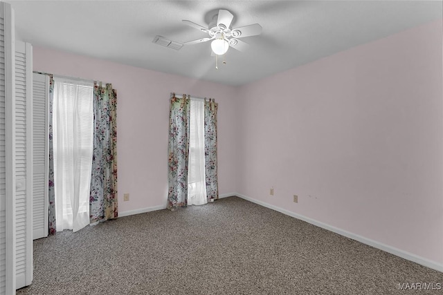 carpeted empty room featuring ceiling fan