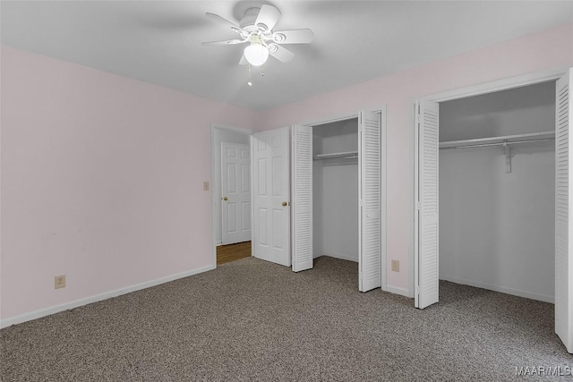 unfurnished bedroom with multiple closets, carpet flooring, and ceiling fan