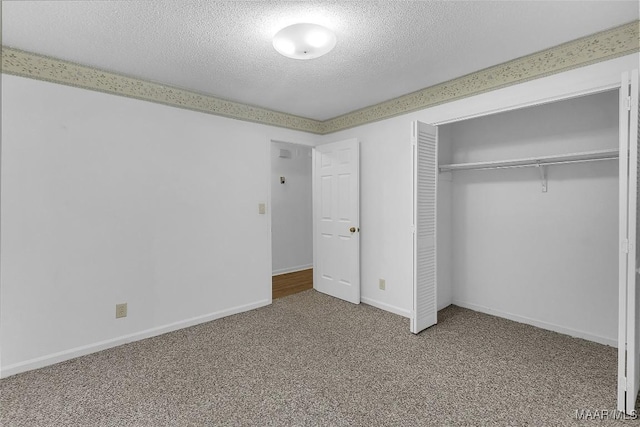 unfurnished bedroom with carpet floors, a textured ceiling, and a closet