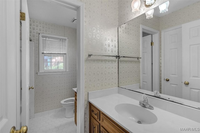 bathroom with tile patterned flooring, vanity, and toilet