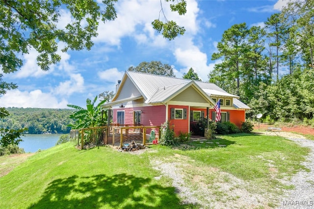 1086 Riverknolle Rd, Tallassee, AL 36078 - rear view of house with a lawn, metal roof, and a deck with water view