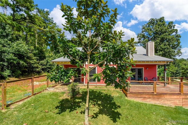 1086 Riverknolle Rd, Tallassee, AL 36078 - rear view of property with a yard, a chimney, a deck, and metal roof
