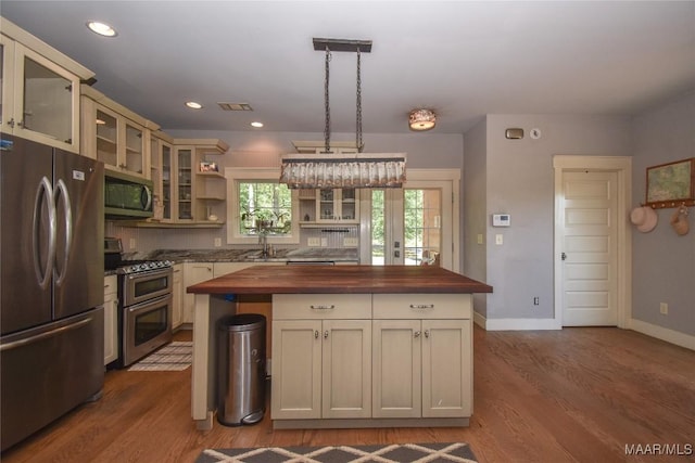 1086 Riverknolle Rd, Tallassee, AL 36078 - kitchen with butcher block counters, open shelves, dark wood finished floors, and appliances with stainless steel finishes