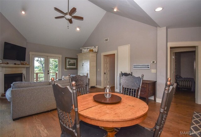 1086 Riverknolle Rd, Tallassee, AL 36078 - dining area with high vaulted ceiling, a fireplace, a ceiling fan, and wood finished floors