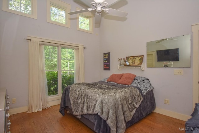1086 Riverknolle Rd, Tallassee, AL 36078 - bedroom featuring ceiling fan, wood finished floors, baseboards, and a high ceiling