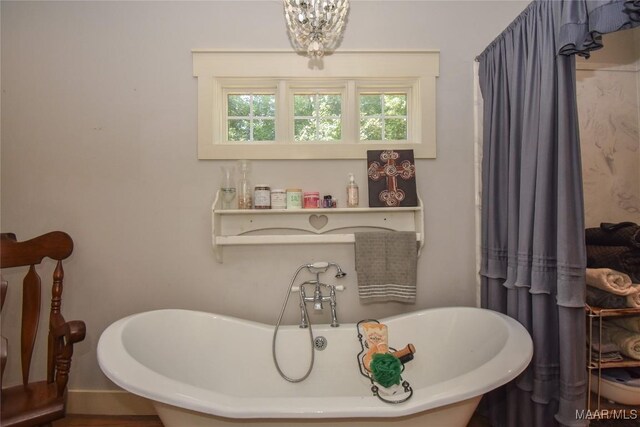 1086 Riverknolle Rd, Tallassee, AL 36078 - bathroom with a notable chandelier and a freestanding tub