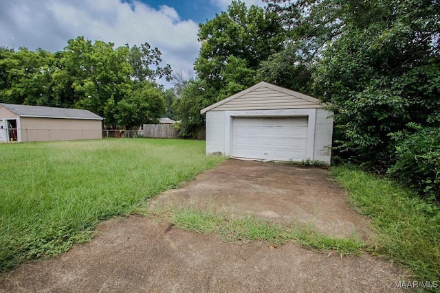 detached garage with driveway and fence