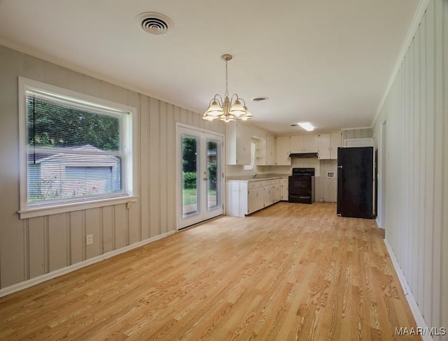 kitchen featuring under cabinet range hood, visible vents, light wood-style floors, light countertops, and black appliances