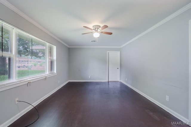 unfurnished room with crown molding, ceiling fan, dark wood finished floors, and baseboards