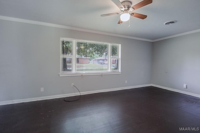 spare room featuring crown molding, dark wood-style flooring, visible vents, and baseboards