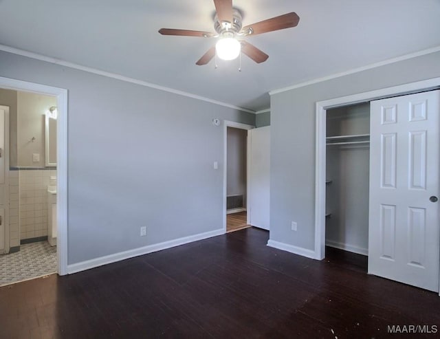 unfurnished bedroom featuring a closet, ornamental molding, connected bathroom, ceiling fan, and wood finished floors