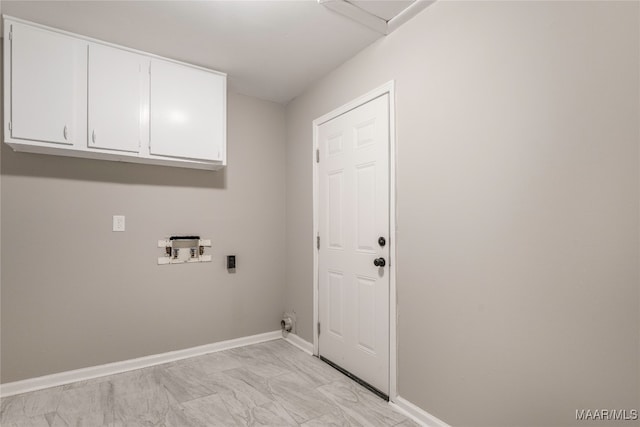 washroom with cabinets and hookup for a washing machine