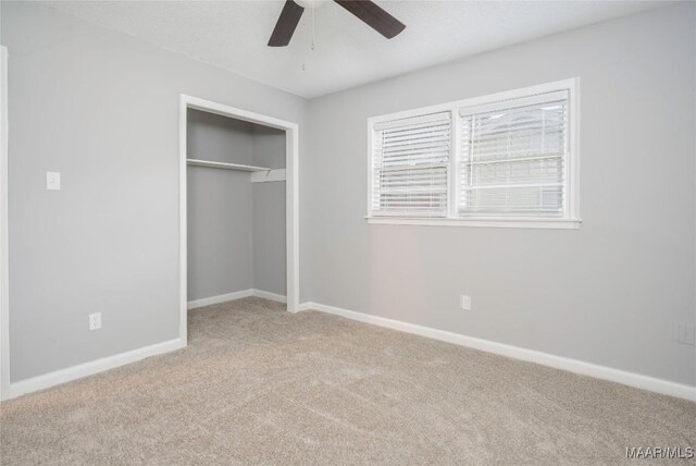 unfurnished bedroom with light carpet, a textured ceiling, a closet, and ceiling fan