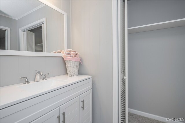 bathroom featuring vanity, crown molding, and tasteful backsplash