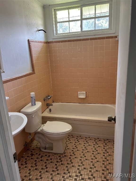 full bathroom featuring tile walls, tile patterned flooring, and toilet