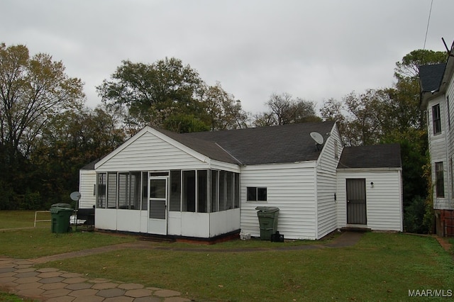 exterior space featuring a sunroom and a yard