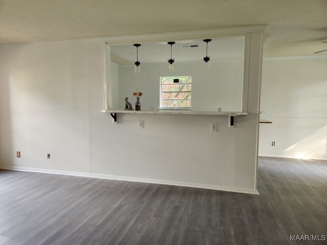 unfurnished room featuring ceiling fan, a textured ceiling, and dark hardwood / wood-style floors