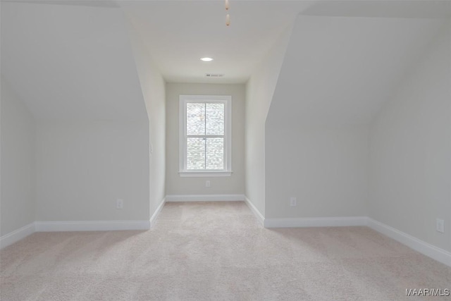 bonus room with visible vents, baseboards, and light colored carpet