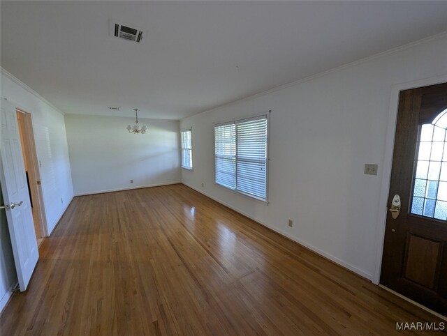 interior space featuring a notable chandelier, hardwood / wood-style flooring, and a wealth of natural light