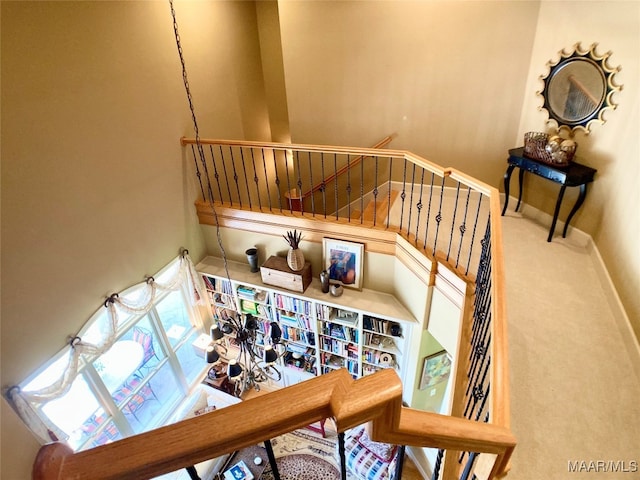 stairway with carpet and a towering ceiling