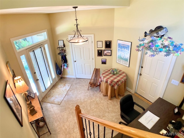 foyer featuring light tile patterned floors and vaulted ceiling