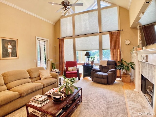 living room featuring high vaulted ceiling, a fireplace, crown molding, and a ceiling fan