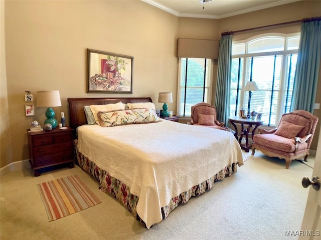 bedroom with carpet floors, ornamental molding, and baseboards