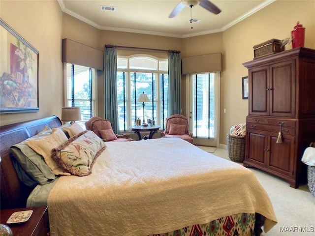 bedroom with ornamental molding, visible vents, ceiling fan, and light colored carpet