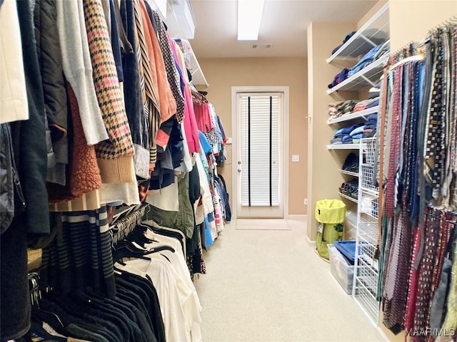 walk in closet featuring carpet flooring and visible vents